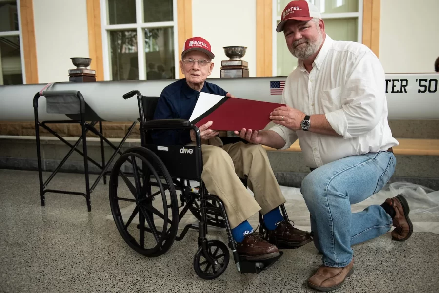 On Saturday April 29, 2023 at Perry Atrium in Pettengill Hall Ralph Sylvester ’50, left, posed for a photo with Bates Rowing Head Coach Peter Steenstra. Coach Steenstra presented Sylvester with a blade during the dedication ceremony, making Sylvester the only non-rower to receive one.