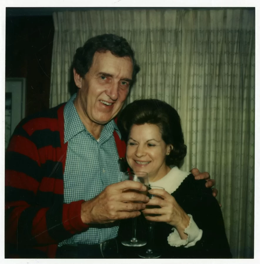 Edmund Muskie at the left and Jane Muskie stands at the right. They are each holding wine glasses.
