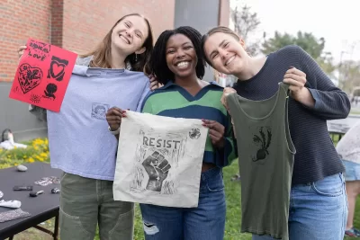 The posted instructions were simple: coat the surface; press, then peel, the block; dry and take home!
Printmaking at Free Press involved rolling ink out onto stamps carved by a variety of talented Bates artists for fellow Bobcats to make designs on the canvas of their choice. 
The annual event, sponsored on May 7 by @batesmultifaith, provided paper, canvas tote bags, and clothes to print on. Participants provided whatever else that required artistic embellishment (t-shirts? jean jackets? A roommate’s bedspread?). No prior art experience or skill was necessary because artists were there to guide everyone through the process.

Multifaith fellows Jilly Scott-Lewis ’27 of Portland, Ore., Rosina Makwabe ’26 of Arusha, Tanzania, and Hana Roggendorf ’27 of West Hartfor, Conn., put together the event.