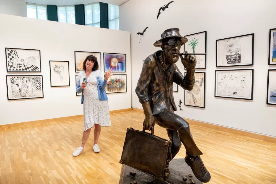 Sadie Williams, Ralph Steadman’s daughter and the managing director of the Ralph Steadman Art Collection, circulates on in the main gallery where an exhibition of her father’s work, “Ralph Steadman: And Another Thing,” opens tomorrow, June 6, 2025, and runs through Oct. 11, 2025, in the Bates Museum of Art.

This extensive traveling exhibition spans over 60 years of Ralph Steadman’s influential and lauded career, and features more than 140 original artworks and ephemera, including sketchbooks, handwritten notes, and personal photographs. Visitors to the exhibition will encounter familiar favorites, like the artist’s illustrations for literary classics such as Lewis Carroll’s Alice in Wonderland and Robert Louis Stevenson’s Treasure Island, as well as works for activist causes, branding iconography, and even a life-sized bronze sculpture.