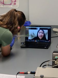 In a sign of the times, senior Emily Woods chats with her remote lab partner, Dessy Yang who is in Shanghai, China.