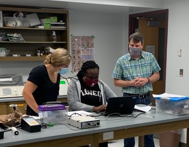 Ryan Bavis works with students Payton Buxton '21 (L) and Prisca Mbunga '21 (R) in his animal physiology class lab where they conducted a respirometery experiment to study cockroach metabolism.