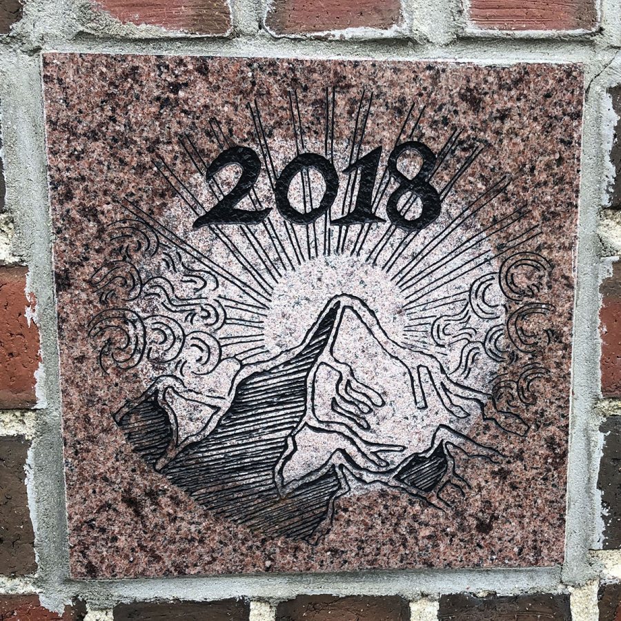 The 2018 ivy stone is on the Alumni Walk side of Pettengill