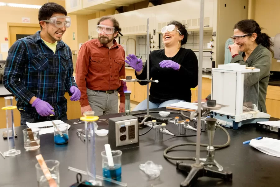 From left, Robert Ibarra '17, a psychology major from Los Angeles; Dana Professor of Chemistry Glen Lawson; Yessenia Saucedo '16, a politics major from Oakland, Calif.; and Associate Professor of Spanish Claudia Aburto Guzmán, enjoy a moment of levity in a Dana Chemistry lab as they use heat to extract copper metal from ore.Why are they laughing?Ibarra had difficulty igniting the fire, and when he succeeded, he registered surprise, much like humans must have responded when they first realized they could reproduce fire, Lawson observed. "It was great to be able to laugh in a space that - at least for me - is so intimidating," says humanist Aburto Guzmán.This moment occurred on the second day of a new interdisciplinary (biological chemistry meets Spanish) Short Term course titled "Intersection of Biomedicine and Human Rights: The Case of the Chilean Mining Experience," co-taught by Lawson and Aburto Guzmán. Students and faculty will soon travel to Chile to explore the intersections between natural scientific inquiry and social and cultural studies. Through historical, scientific, cultural, and bioethical lenses, the group will examine biomedical science in Latin America and the struggle for civil, human, and health rights by workers in the Chilean mining industry since the nineteenth century.