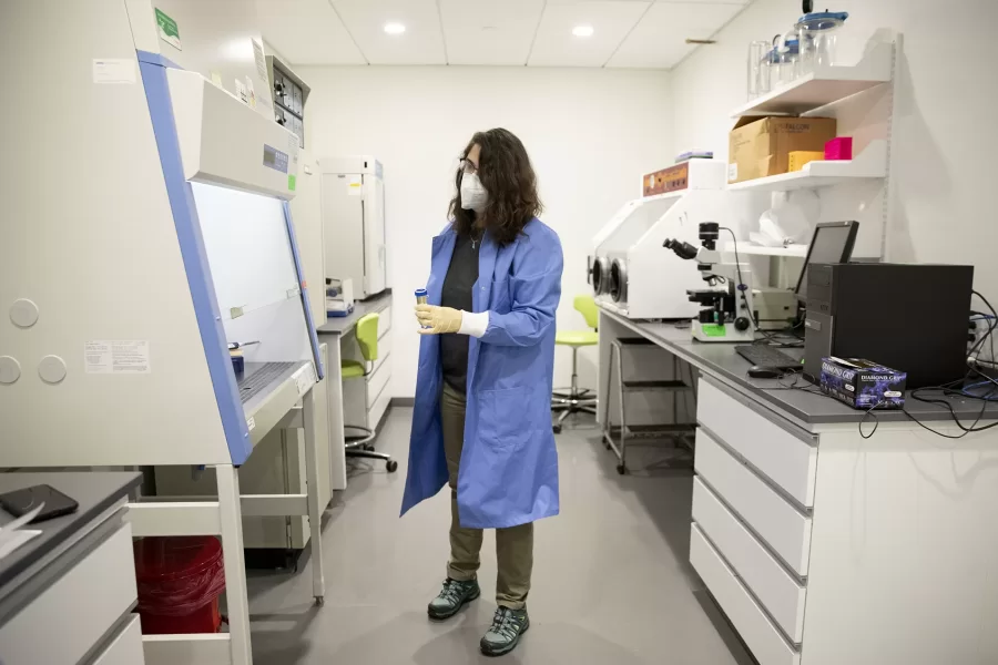 Professor of Chemistry and Biochemistry Paula Schlax in her Bonney Science Center Lab and office, alone, with student, and colleague Colleen O'Loughlin.