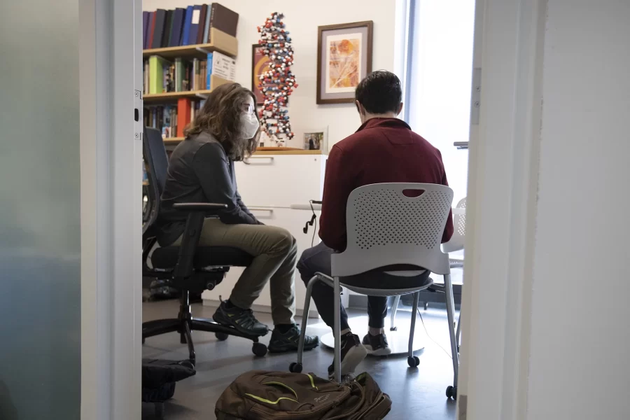 Professor of Chemistry and Biochemistry Paula Schlax in her Bonney Science Center Lab and office, alone, with student, and colleague Colleen O'Loughlin.