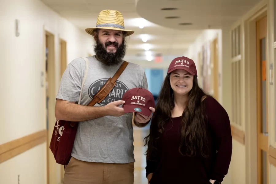 They wanted hats and representation for their students, said @bates.classical.and.medieval studies professors Liana Brent and Mark Tizzoni, speaking outside of their second-floor Pettengill Hall offices.
“We’re a small program in Classical and Medieval Studies, and we have really enthusiastic students and faculty, Brent said, seen here checking out her new head gear in her office mirror.
In thinking of a design, she and her colleagues considered columns or something that dealt with the classical past, “but we are classical AND medieval studies,” she pointed out, so their choice for a griffin — a little mythological creature or symbol with the body of a lion and the head and wings of an eagle — “spans the classical and medieval world. And it’s one that is not associated with the whiteness of the past the way a column or a temple might be, so it really hints at some of our values and ideals in this program,” Brent said.