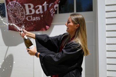 Scenes from Commencement Day, May 31, 2020. Anna Glass '20 of Wilton, Maine, celebrates at home with her parents, Marc and Wendy Glass .@berglicht