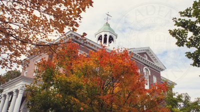 Hathorn Hall surrounded by fall foliage with Bates seal