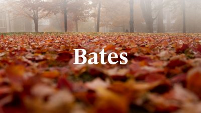 White Bates wordmark over fallen colorful foliage