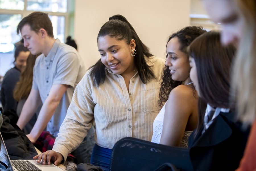Perla Figuereo ’21 (center) presents a digital project developed with, to her left, classmate Alya Yousuf ’21 as part of their fall 2019 coursework in “Data Cultures,” taught by Assistant Professor of Digital and Computational Studies Anelise Hanson Shrout. (Phyllis Graber Jensen/Bates College)