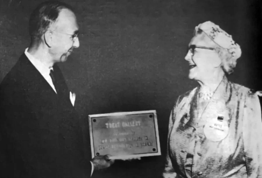 man and woman posing, man holding plaque