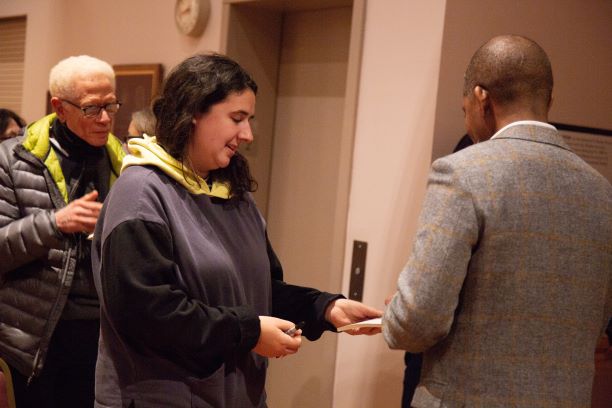 Professor Emeritus Charles Carnegie (l) at a poetry reading by Myronn Hardy (r)