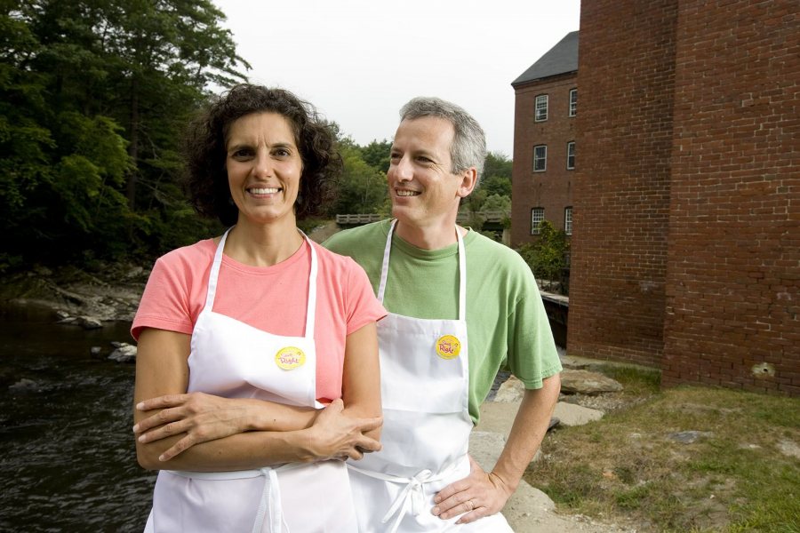 In 2008, Beth George '85 and Tim Kane '85 pose outside their family-owned company, Spelt Right Inc. in the Sparhawk Mill in Yarmouth, Maine. (Phyllis Graber Jensen/Bates College)