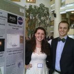 Sophia and Josh standing with their poster