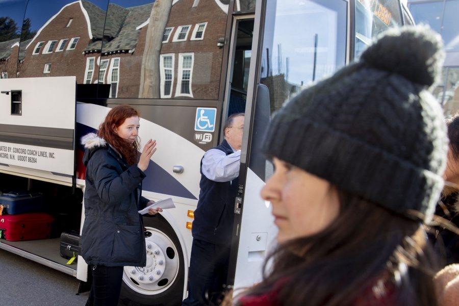 Students gather in front of Chase Hall to take two buses that will take them on the first leg of their trips home. One is a Concord Trailways bus, regularly scheduled daily for 3:30 p.m. pickup. The other is a bus chartered by the College.