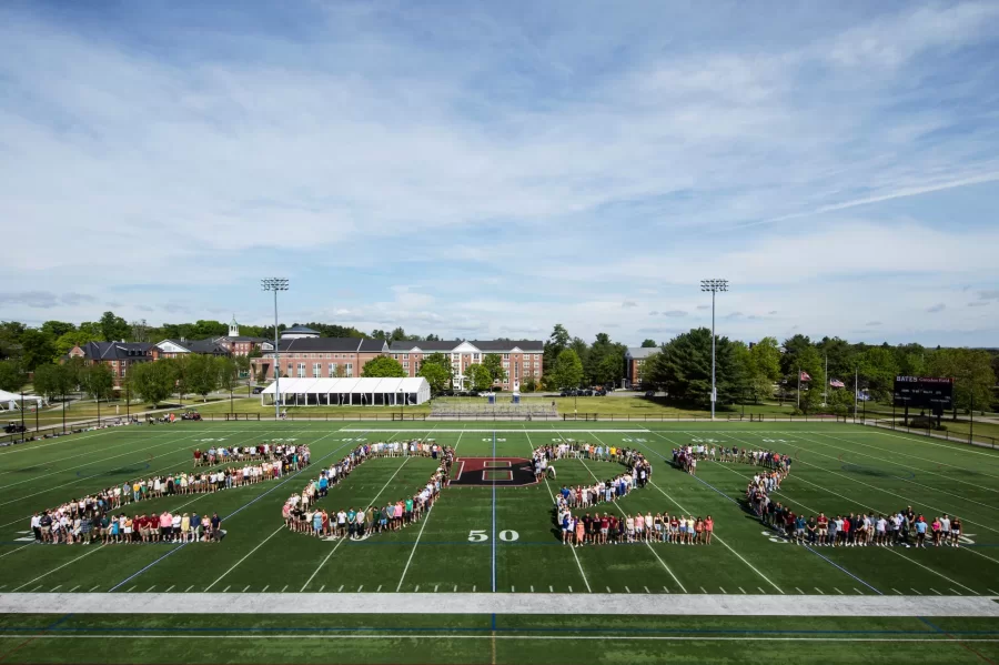 The Class of 2022 standing on Garcelon Field, lined up to spell out “2022” on the field.