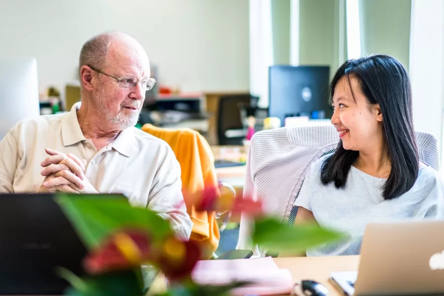 Bill Hiss ’66 is seen meeting with Ngan Dinh ’02 at Fulbright University Vietnam in Ho Chi Minh City, where Dinh is the President and Hiss was a volunteer consultant on admissions, financial aid and communications. (Quinn Mattingly for Bates College)