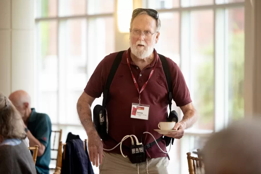President Garry W. Jenkins addresses members of the Class of 1975 at their 50th Reunion Breakfast in Pettengill Hall’s Perry Atrium on June 6, 2025. He presented to awards: one, Bates Best,  to Susan Bourgault Akie ’75 P’08, and the other. The 2025 50th Reunion Philanthropic Leadership Award, posthumously, to John R. Hester ’75 whose brother Andy Hester (in green), nephew and Andy’s son Geoffrey Hester, John’s brother Mike Hester (in brown) with John’s wife Bronwen, accepted the honor.