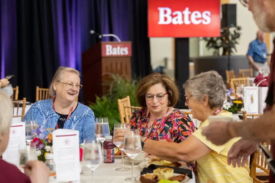 President Garry W. Jenkins addresses members of the Class of 1975 at their 50th Reunion Breakfast in Pettengill Hall’s Perry Atrium on June 6, 2025. He presented to awards: one, Bates Best,  to Susan Bourgault Akie ’75 P’08, and the other. The 2025 50th Reunion Philanthropic Leadership Award, posthumously, to John R. Hester ’75 whose brother Andy Hester (in green), nephew and Andy’s son Geoffrey Hester, John’s brother Mike Hester (in brown) with John’s wife Bronwen, accepted the honor.