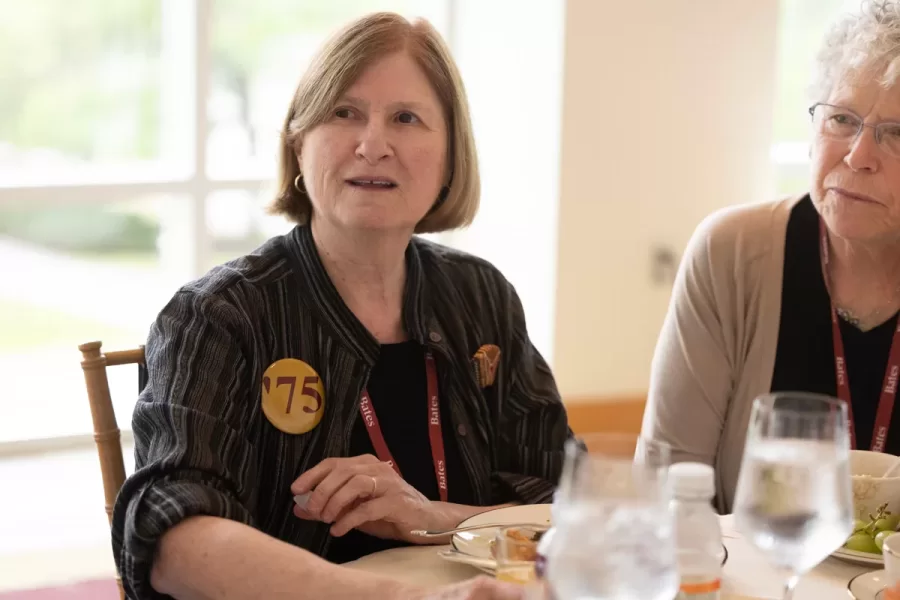 President Garry W. Jenkins addresses members of the Class of 1975 at their 50th Reunion Breakfast in Pettengill Hall’s Perry Atrium on June 6, 2025. He presented to awards: one, Bates Best,  to Susan Bourgault Akie ’75 P’08, and the other. The 2025 50th Reunion Philanthropic Leadership Award, posthumously, to John R. Hester ’75 whose brother Andy Hester (in green), nephew and Andy’s son Geoffrey Hester, John’s brother Mike Hester (in brown) with John’s wife Bronwen, accepted the honor.