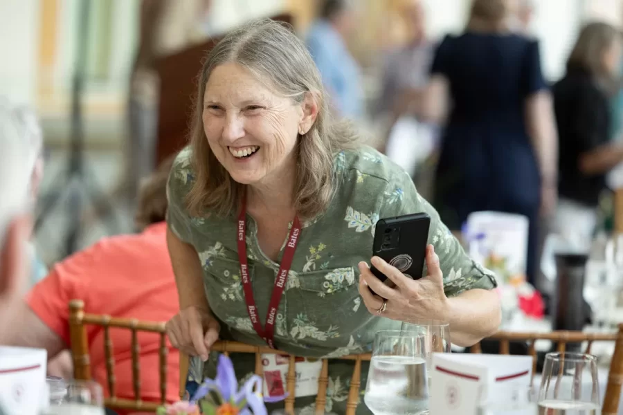 President Garry W. Jenkins addresses members of the Class of 1975 at their 50th Reunion Breakfast in Pettengill Hall’s Perry Atrium on June 6, 2025. He presented to awards: one, Bates Best,  to Susan Bourgault Akie ’75 P’08, and the other. The 2025 50th Reunion Philanthropic Leadership Award, posthumously, to John R. Hester ’75 whose brother Andy Hester (in green), nephew and Andy’s son Geoffrey Hester, John’s brother Mike Hester (in brown) with John’s wife Bronwen, accepted the honor.