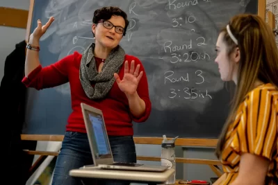 Associate Professor Carrie Diaz Eaton teaches in front of a chalkboard