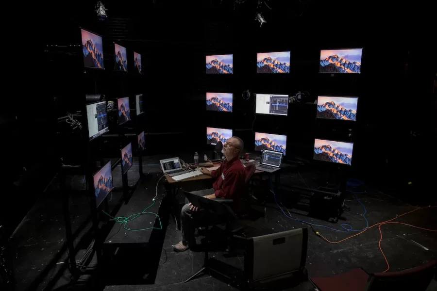 Senior Lecturer and Managing Director of Theater and Dance Micheal Ready works on technical cues with 18 monitors that will form the backdrop for the upcoming theater production of  Nikolai Gogol's "Diary of a Madman" performed by Nate Stephenson '18.