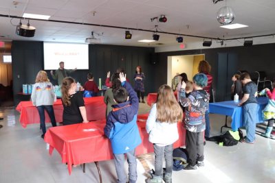 Ross Ackerman ‘19, president of Helicase Biology Club, leading an activity on Strawberry DNA Extraction at an Auburn Community Learning Center event.