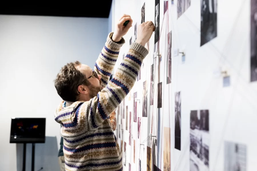 Ben Peck, Associate College Librarian for Research Services, contributes to the interactive experience of the "Who We Are / Who Are We?' exhibit at Maine MILL.