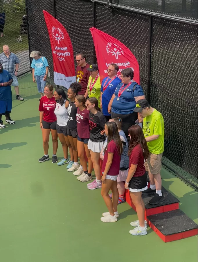 Special Olympians and Bates students gather on the Bates tennis courts-turned Olympic podium for a photo finish.