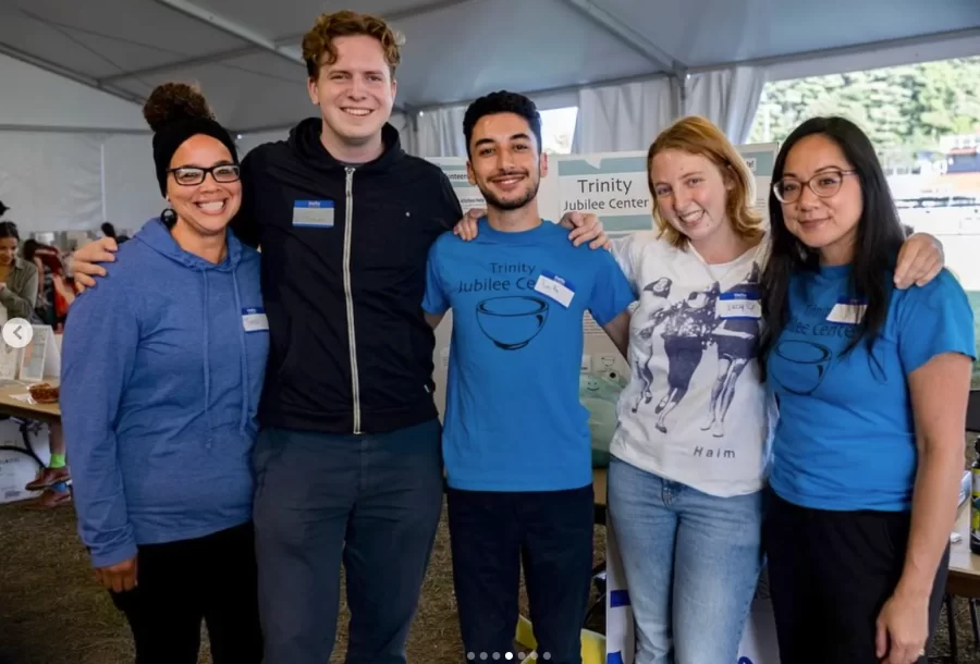 Community partners from Trinity Jubilee Center stand shoulder to shoulder with Bates student volunteers at the Activities Fair.