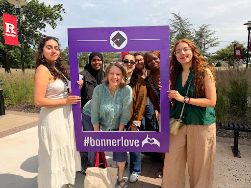 A group of conference attendees pose with an Instagram cutout
