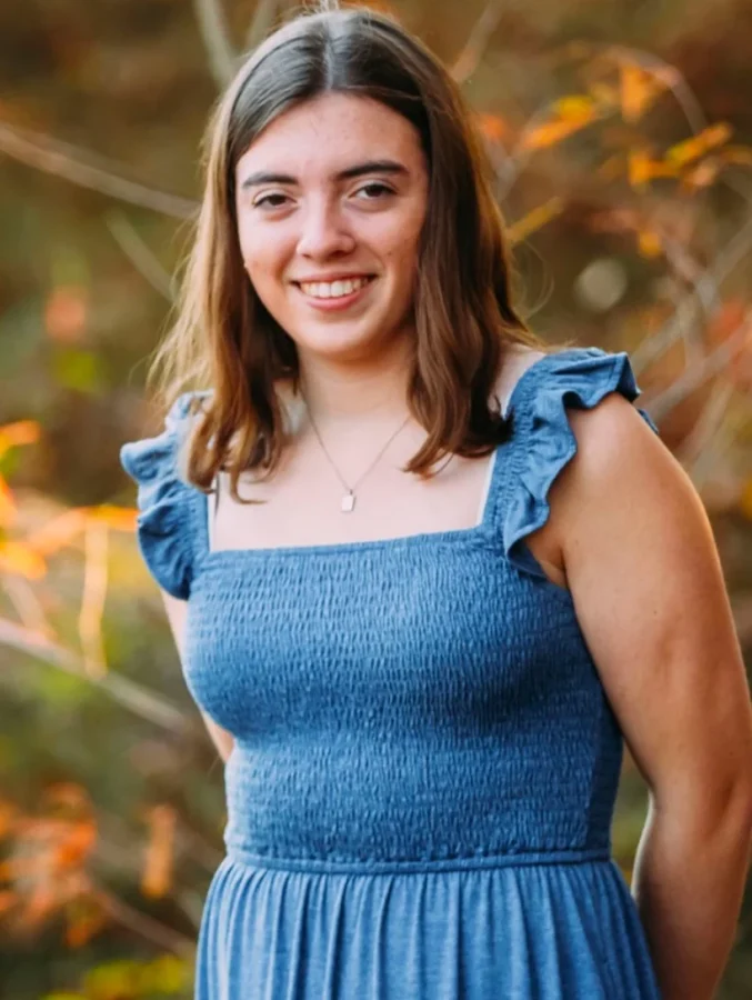 a student poses with natural scenery in the background
