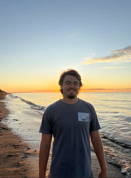 a student standing on a beach