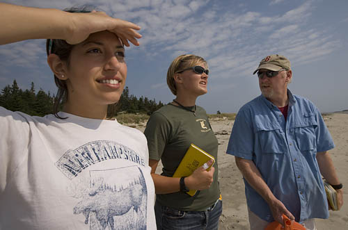 From left, geology thesis students Dana Oster 09 and Emily Chandler 09 work with Professor of Geology Mike Retelle to study climate-induced changes at Phippsburgs Seawall Beach. 