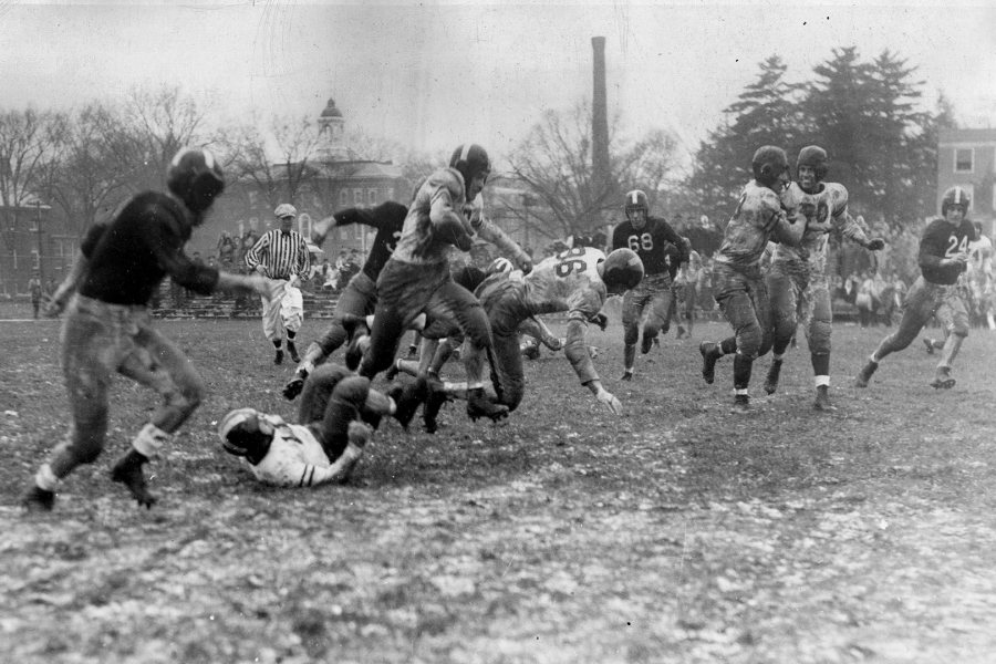 Allen Howlett '49 picks up rushing yardage in Bates' 6-0 win over Bowdoin on rainy, muddy Garcelon Field before 3,000 on Back to Bates weekend on Nov. 2, 1946. (Muskie Archives and Special Collections Library)