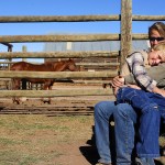 Krista Kaplan and her son Alex Burleigh sit in the sun after guests leave for their morning ride. Photograph by Shauna Stephenson.
