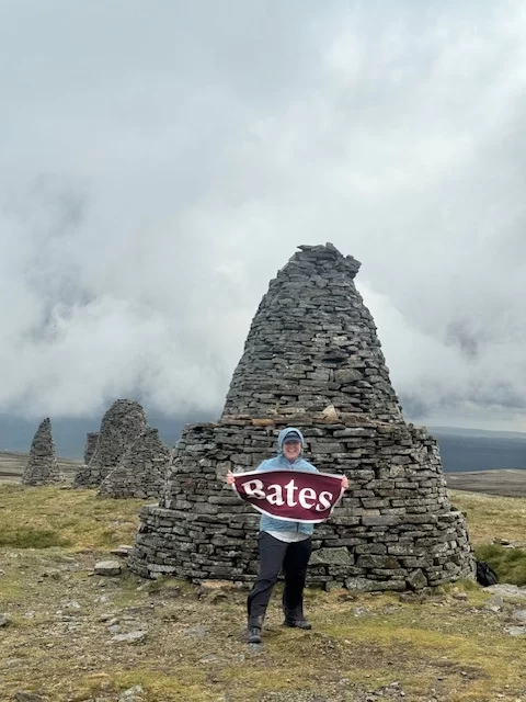 Marcia Call poses by an ancient stone cairn in England
