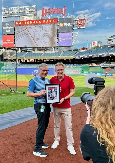 Bill Walsh presents an award to sportscaster Bob Carpenter