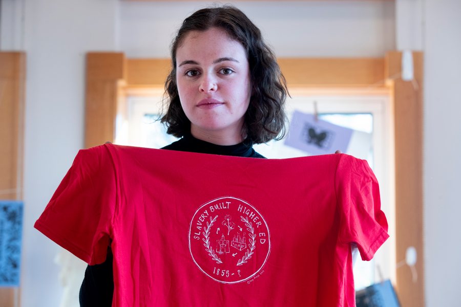 MLK Day presenter Emma Soler '20, whose yearlong history thesis examines how the role of revenue from slave-picked cotton in the origins of Bates College, poses with a shirt she made during the November 2019 “Free Press Bates" printmaking event. (Phyllis Graber Jensen/Bates College)