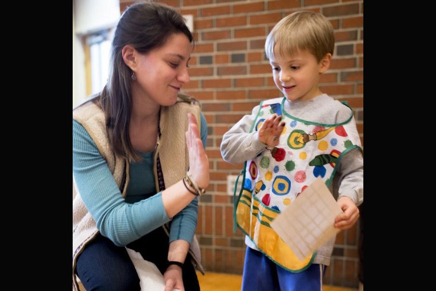 Theodore Martin, 4, of Durham shows his mom, Valeska Martin, the print he made during the family printmaking workshop at Bates College in Lewiston on Monday. Bates College Museum of Art intern Hannah Gottlieb showed examples of prints from the museum's collection. She provided materials to make prints with items such as broccoli, toy cars, spinach and bubble wrap. Martin's 6-year-old brother, Elliott, also attended the workshop with about 15 other children and their families.