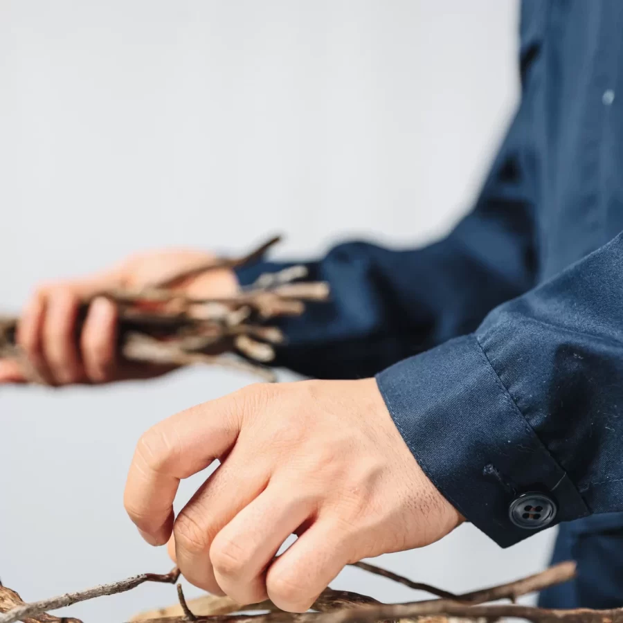 Miguel Ángel Pacheco,  to carry ones..., 2024, performance, installation on sticks and house façade