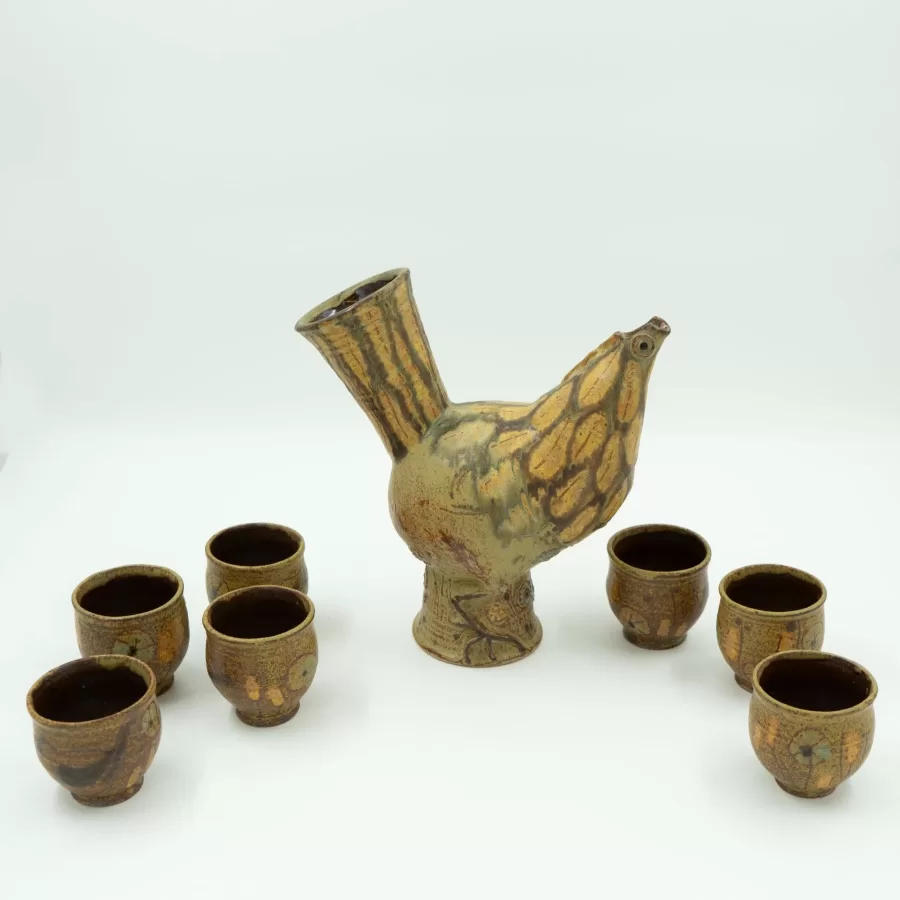 Frances Senska, Chicken Wine Set: Carafe and Seven Cups, ca. 1960, stoneware, wheel thrown, incised, glazes, carafe: 10 h x 9 w x 5 ½  d inches, cups: 3 h x 2 ½ dia. inches.
