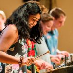 Zofia Ahmad '19 of Palo Alto, Calif. joins classmates for an encore at the Bates Steel Pan Orchestra concert.The Bates Steel Pan Orchestra, under the direction of Duncan Hardy, performs traditional West Indies arrangements in the Olin Concert Hall on Monday, Dec. 7th 2015.