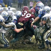 Four years before the advent of artifical turf on Garcelon Field, this image of Jamie Walker ’07 of Needham, Mass., moving a pile of Colby defenders during a game in October 2006 later appeared in Sports Illustrated. (Daryn Slover for Bates College)