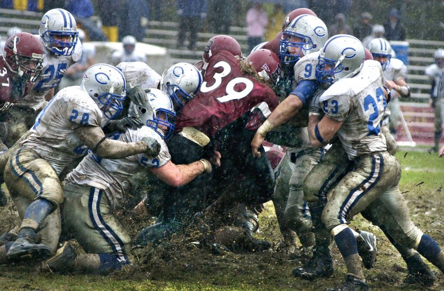 Four years before the advent of artifical turf on Garcelon Field, this image of Jamie Walker ’07 of Needham, Mass., moving a pile of Colby defenders during a game in October 2006 later appeared in Sports Illustrated. (Daryn Slover for Bates College)