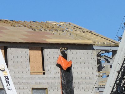 Placement of roof panels on the west wing of the new student housing is nearly done. (Doug Hubley/Bates College)