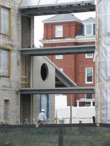 Rand Hall seen through the west bridge of the new housing. (Doug Hubley/Bates College)