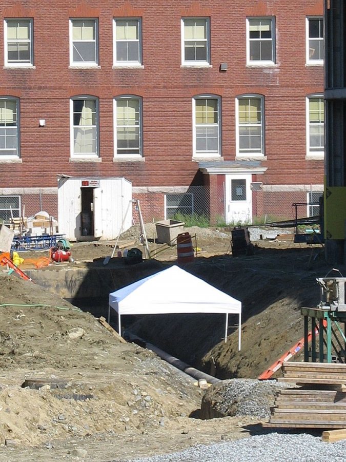 Complete with a tent to shield workers from the sun, this steam-line trench is south of Commons. (Doug Hubley/Bates College)